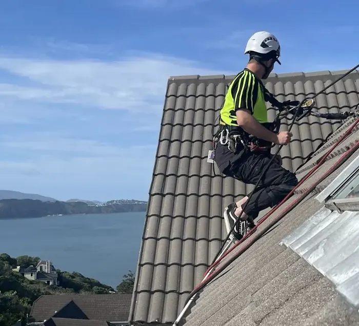 Rope access technician assessing an elevated roof
