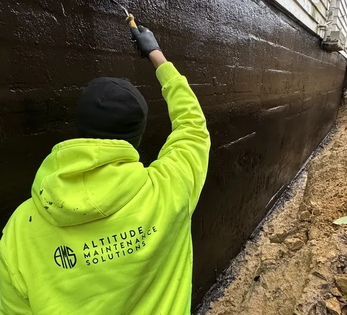 Altitude technician applying a waterproofing system